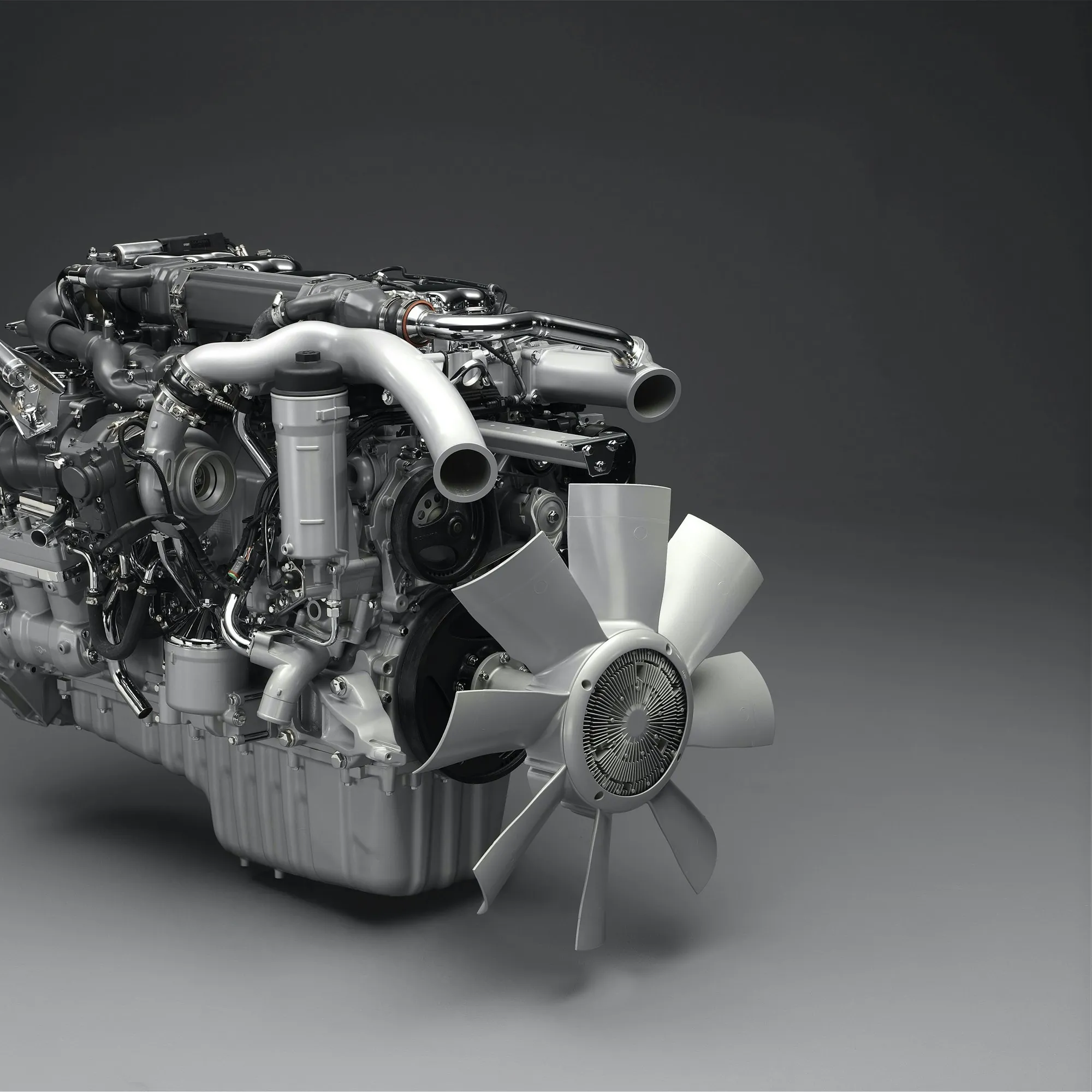 Clean diesel engine with turbocharger and intake visible on a studio backdrop