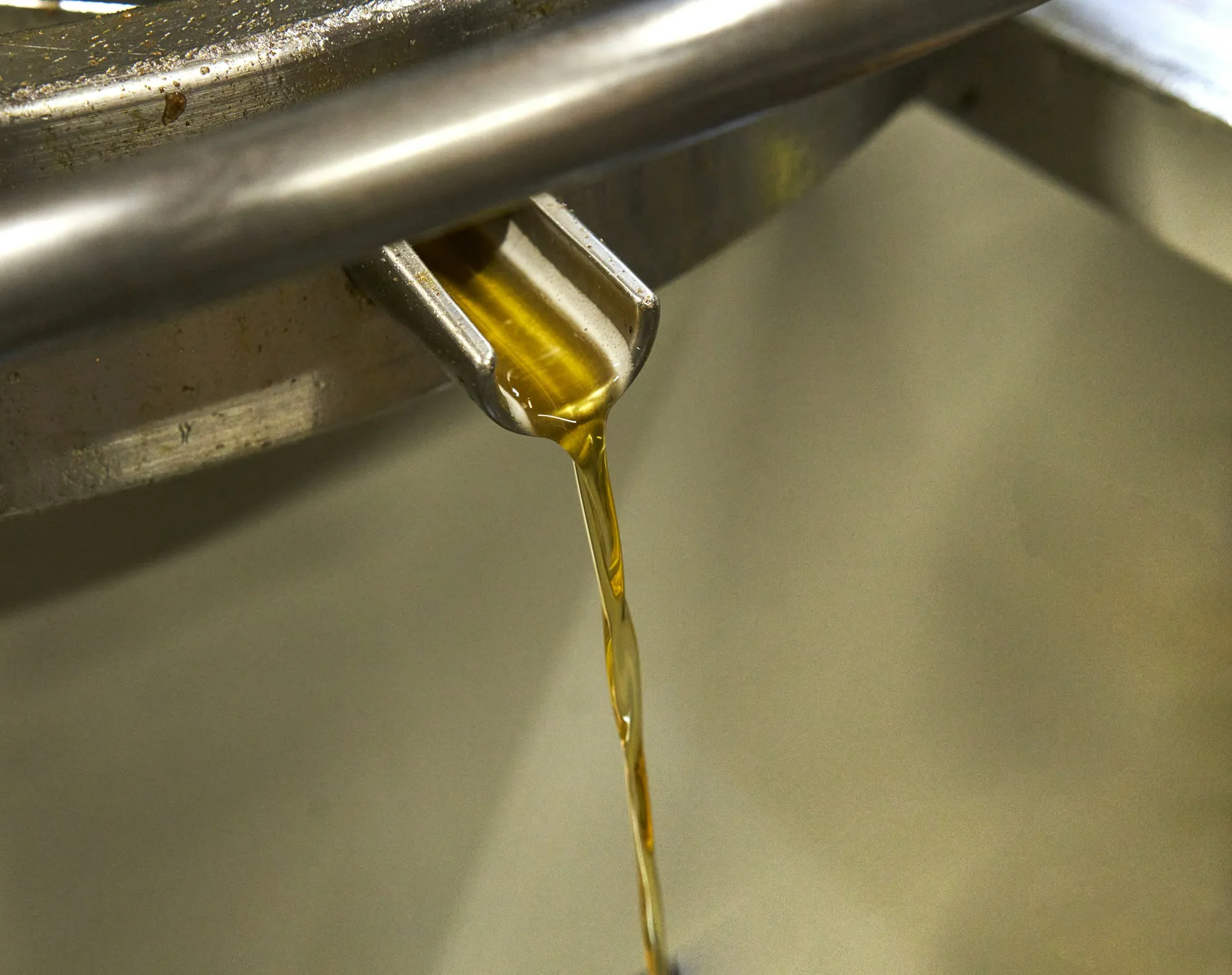 Fresh engine oil being poured during a routine oil change