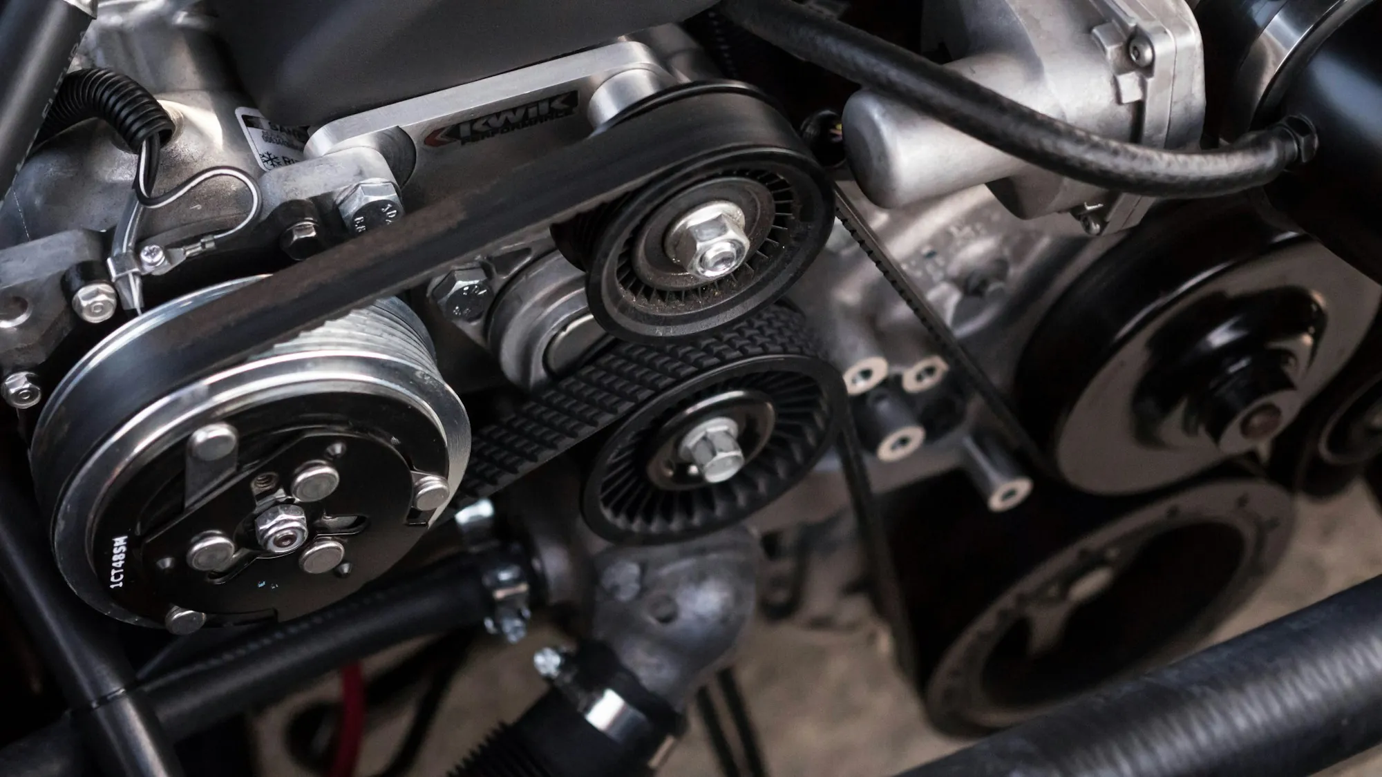 Engine accessory belts and pulleys on a running engine